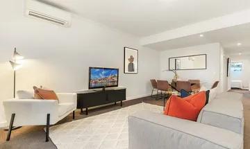 CONTEMPORARY DUAL LEVEL APARTMENT IN BUZZING CENTRAL LOCATION